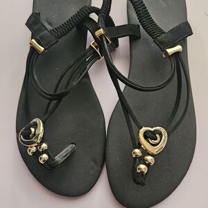 Elegant Black Sandals with Gold Heart Details
